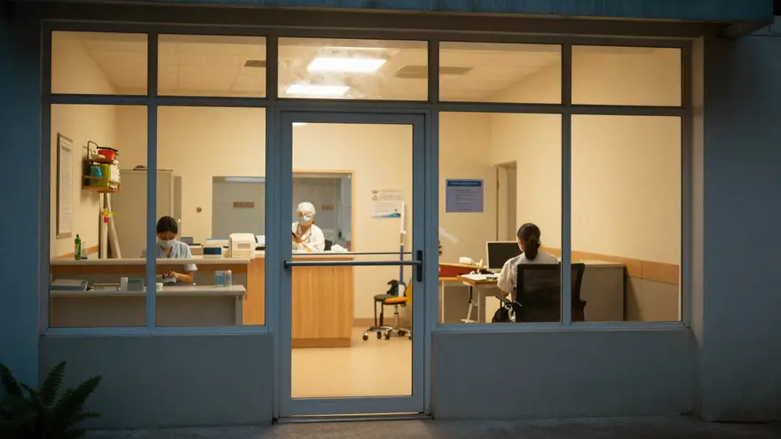 A vet clinic entrance in the evening with warm lighting and clear signage visible through the door